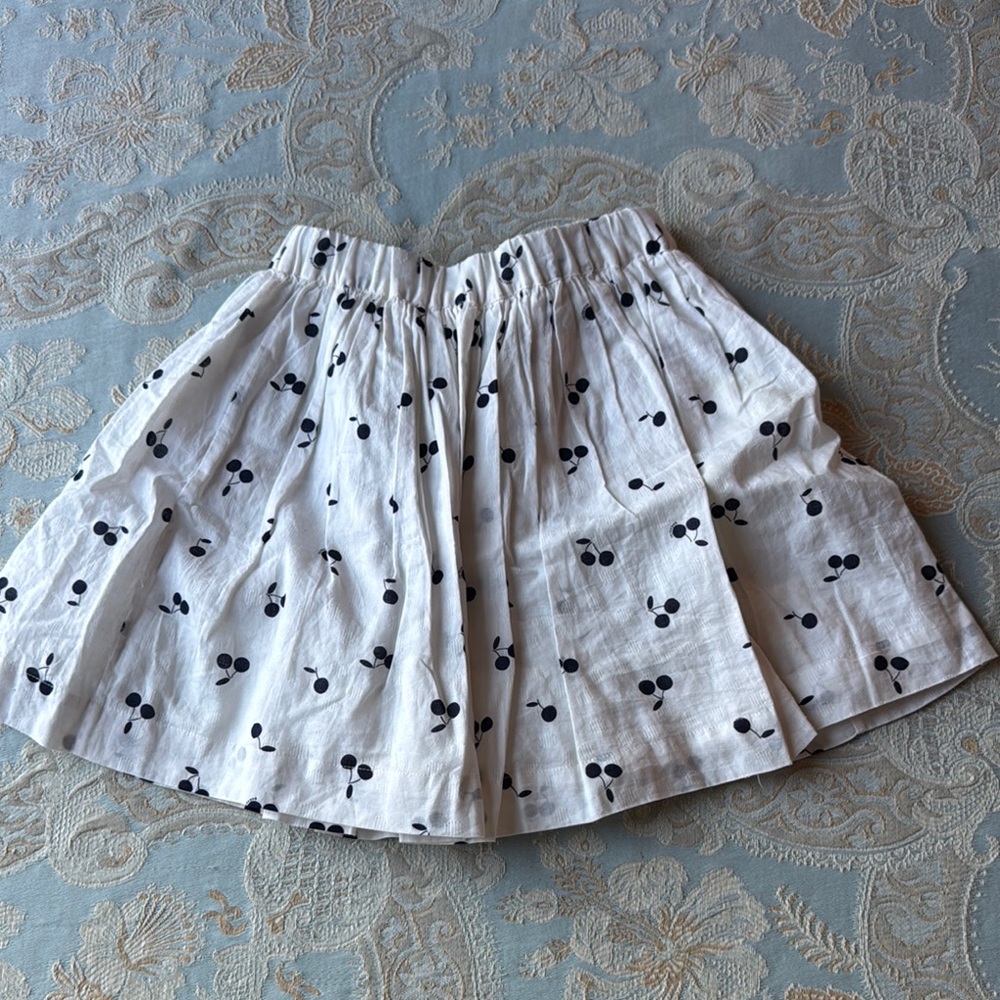 Bonpoint skirt with navy (almost black) signature cherries. Excellent